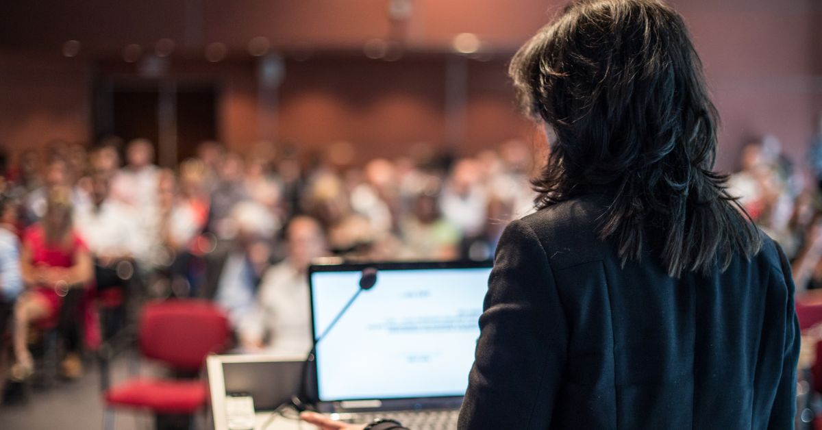 Person presenting at a corporate event