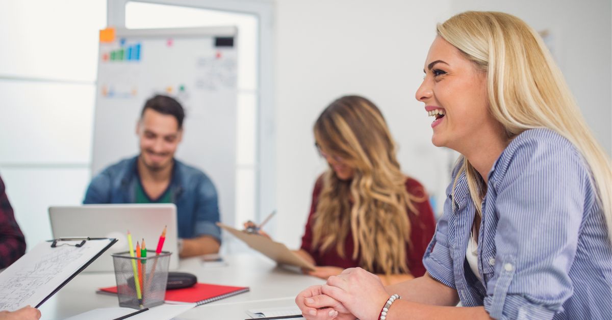 A person smiling in a team meeting