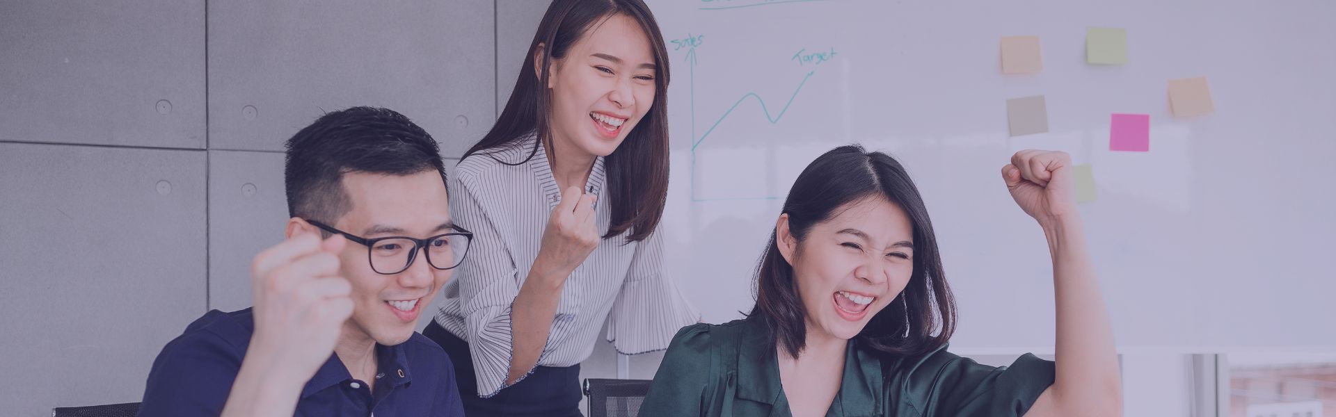 Happy team using a computer