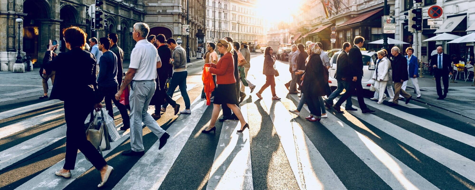 Different people crossing the road on the same crosswalk