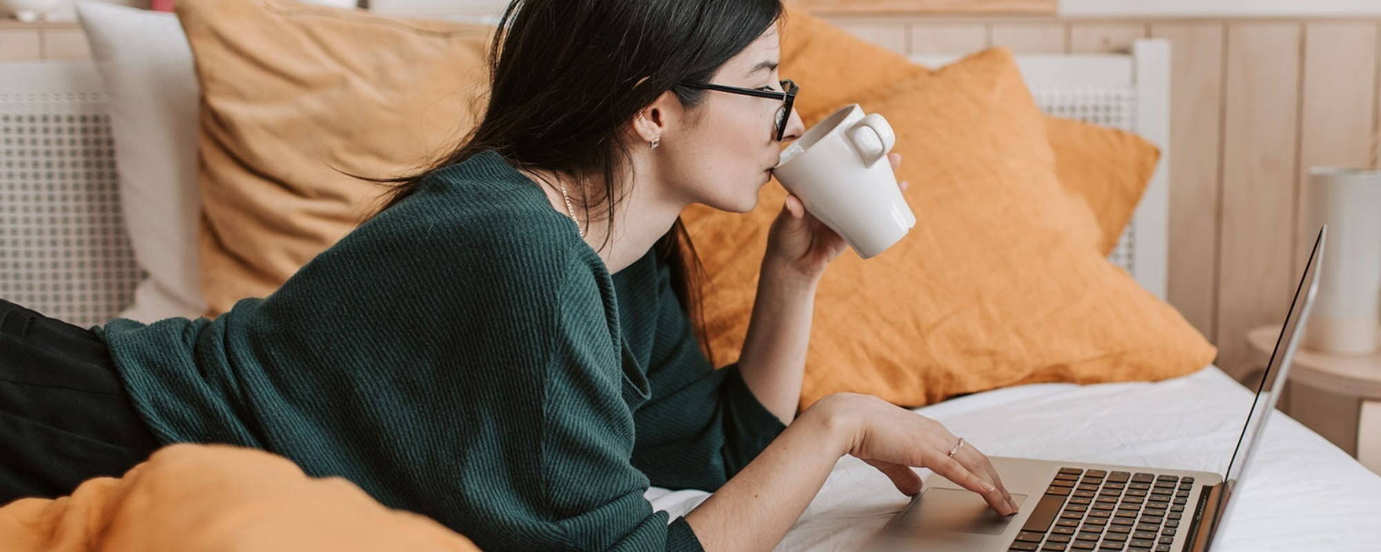 Person working on laptop while having a coffee